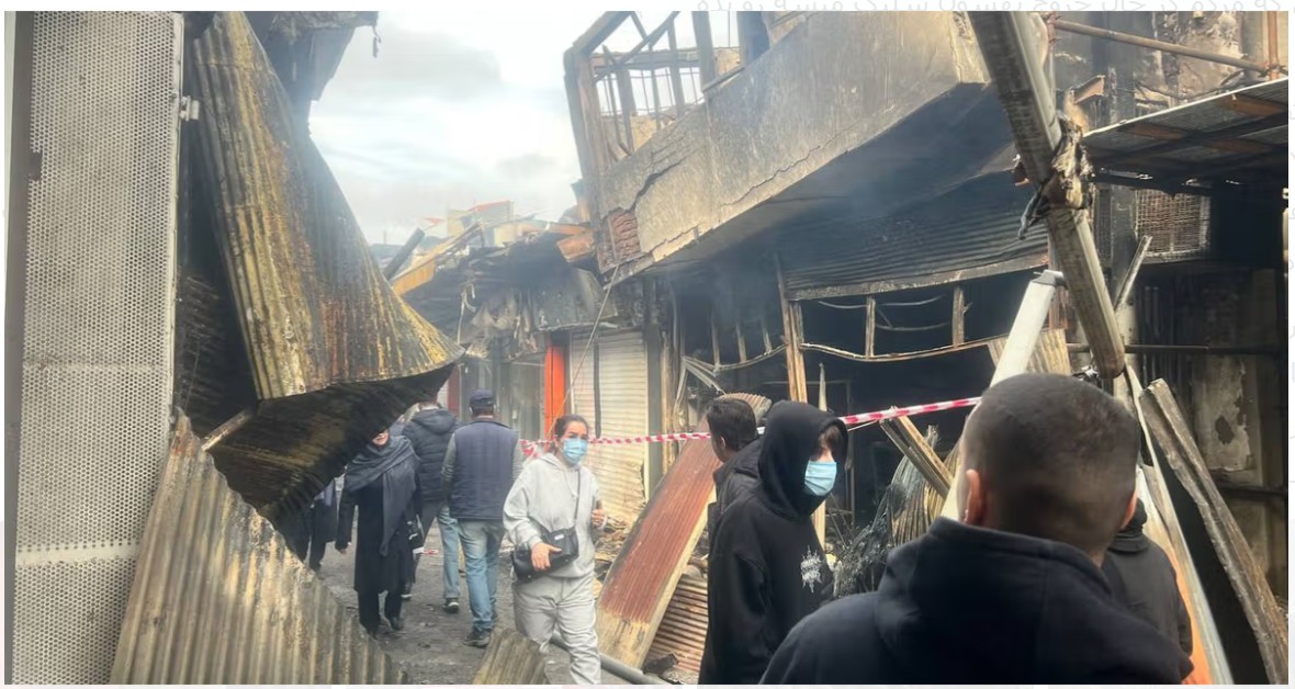 Visual evidence from Rasht bazaar — abandoned shoes and burnt structures.